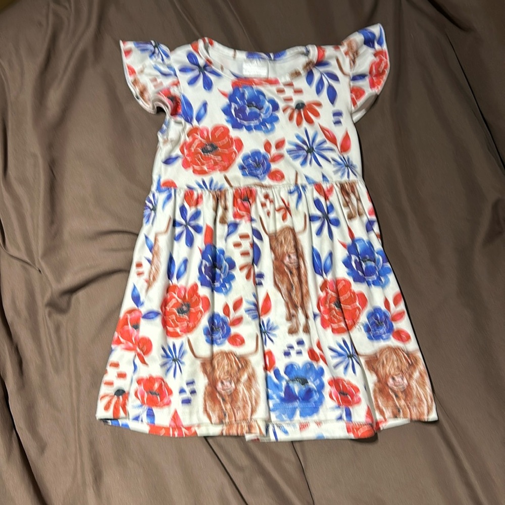 Size 1-2 year old dress. It’s got flowers and highland cows on it